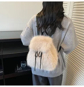 Close-up of fluffy apricot faux fur texture and black straps on a trendy plush backpack