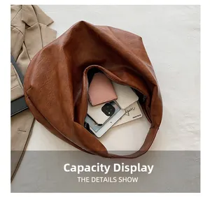 Detailed capacity display of the large brown tote bag showing internal storage space