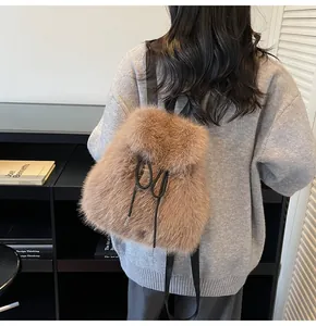 Detailed view of brown plush faux fur backpack with black drawstring and slim straps