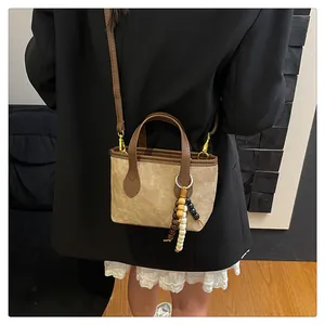 Detail of vintage beige crossbody bag with premium wooden beads and leather handle
