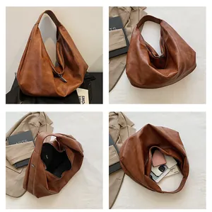 Detail of the brown PU leather hobo bag showing spacious interior and soft leather texture