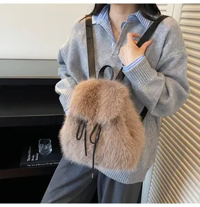 Detailed texture of brown faux fur backpack with black drawstrings and slim shoulder straps