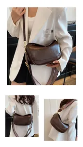 Detail of retro dark brown crescent bag with textured faux leather and dual straps