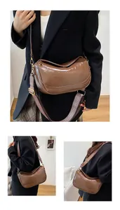 Detail of vintage brown leather crescent bag with geometric woven strap and gold hooks