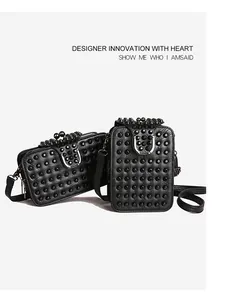 Detail view of black studded crossbody bag with metallic hardware and PU leather texture