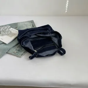 Minimalist navy blue denim tote bag showing interior structure and zip pocket detail