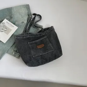 Minimalist large capacity charcoal denim tote bag with leather logo and artistic props