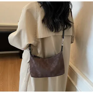 Borsa a mezzaluna marrone a spalla che mostra dimensioni e texture opaca vintage