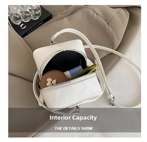 Interior view showing the storage capacity of the white patent leather square crossbody bag