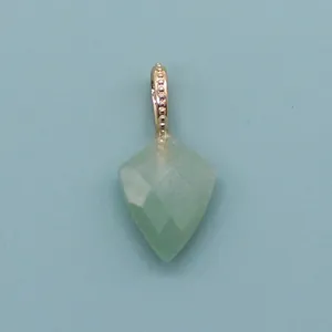 Close-up of faceted shield-shaped green natural stone pendant with golden beaded bail