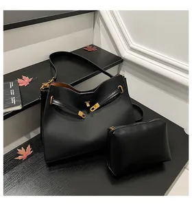 Black vintage textured tote bag set with gold hardware and matching cosmetic pouch