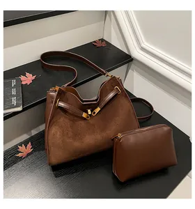 Chocolate brown suede bucket bag with matching small zippered pouch set in fall style