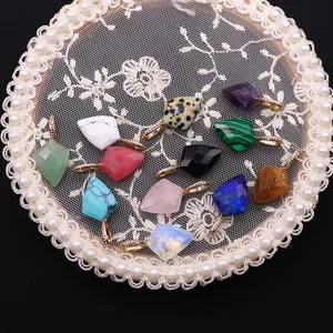 Set of 11 faceted shield-shaped gemstone pendants with gold rhinestone bail on lace frame