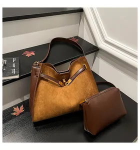 Brown vintage matte Kelly bag with contrast leather trim and golden twist-lock closure