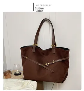 Detail view of coffee brown suede tote bag featuring vintage gold buckles and leather straps