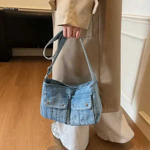 Retro denim tote bag with dual front pockets and adjustable strap for casual daily wear