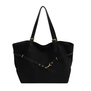 Retro black faux suede tote bag with adjustable gold buckles and spacious interior