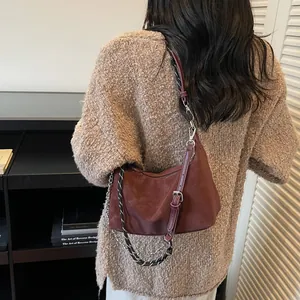 Borsa a mezzaluna bordeaux con catena in metallo e tracolla intrecciata casual