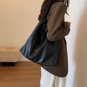Large black pleated leather tote bag for women, minimalist urban commuting style