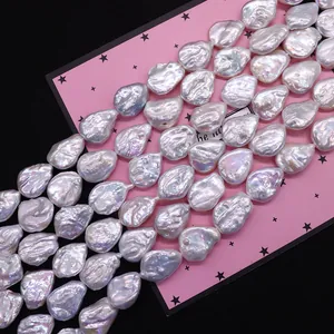 Strands of white baroque freshwater pearls with high luster on pink star card