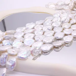 Irregular white baroque freshwater pearls for DIY jewelry making on a reflective surface