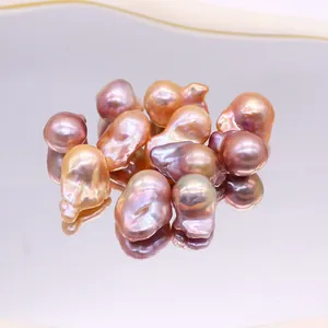 Natural purple baroque freshwater pearls with metallic luster on a mirror tray for DIY jewelry