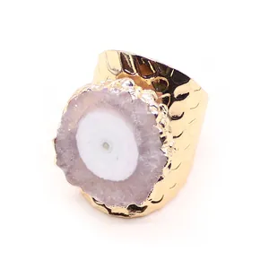 Detalle de banda de metal martillado dorado con cristal de geoda de ágata púrpura natural