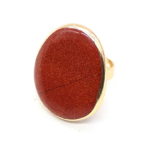 Macro detail of oval Red Jasper stone featuring natural textures on a golden open ring band