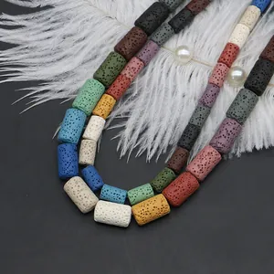 Mix of colorful cylindrical lava stone beads for DIY jewelry making on dark background