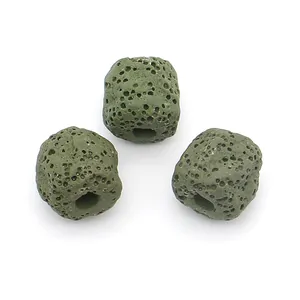 Macro shot of three dark green cubic lava stones with porous texture for DIY jewelry