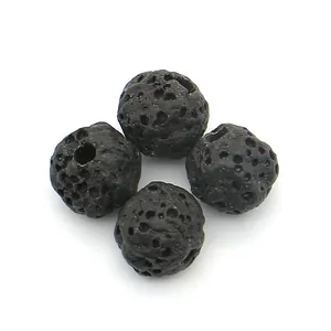 Macro detail of natural black lava rock round beads with porous texture and through holes