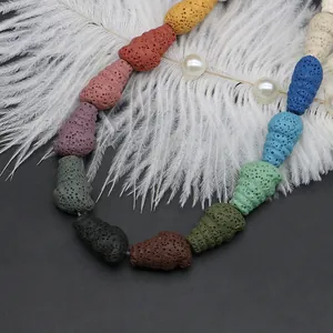 Colorful lava stone beads in spiral conch shapes for DIY jewelry making on dark background