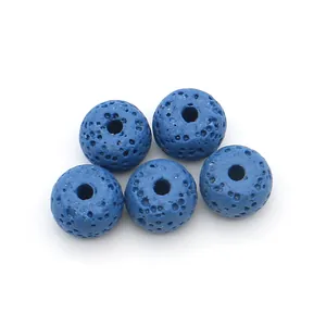 Macro detail of five blue porous volcanic lava rock beads for DIY jewelry making