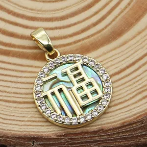 Detailed macro view of a gold Fu pendant with shell texture and sparkling crystal border