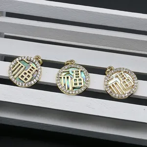 Golden round Fu character pendants with shimmering mother of pearl and crystal inlay