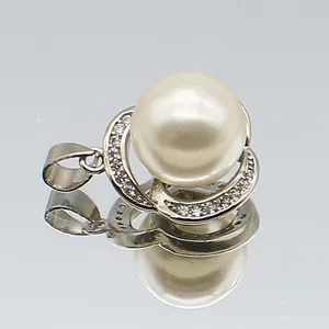 Detailed view of silver five-petal flower pearl pendant with sparkling cubic zirconia inlay