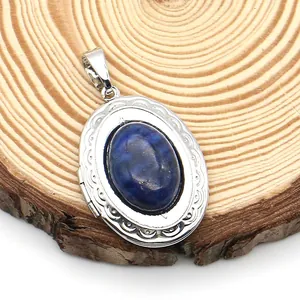 Detail view of a vintage oval locket pendant with blue lapis lazuli on a wooden base