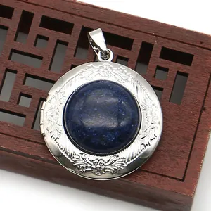Macro view of silver floral locket featuring a deep blue gemstone inlay and detailed relief