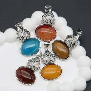 Set of five natural stone gourd pendants with engraved silver floral pattern on a white tray