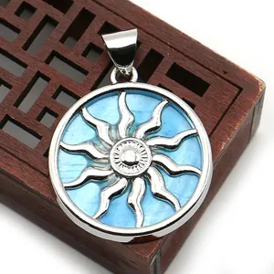 Macro view of blue sunburst shell pendant with polished silver plating and sun pattern