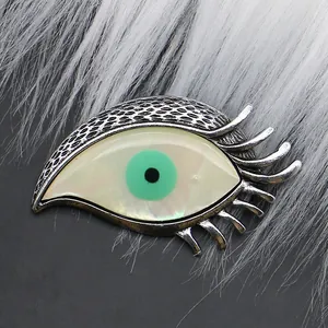 Evil eye feather brooch with iridescent shell inlay and vintage scale textured metal
