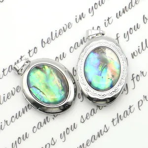 Oval silver locket pendant with iridescent abalone shell inlay and engraved edges