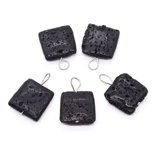 Detailed view of square black volcanic lava stone pendants with silver metal loops