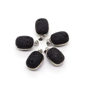 Detailed close-up of 5 oval black lava stone pendants with silver metal edge wrapping
