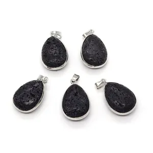 Macro detail of teardrop lava stone pendants with silver plated metal edging and bails