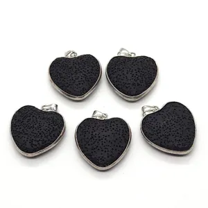Detailed view of five heart-shaped natural black lava stone pendants with silver metal edging