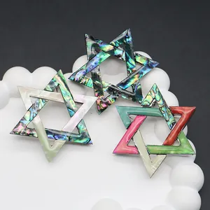 Broches clásicos de estrella con nácar de abulón y reflejos irisados sobre metal