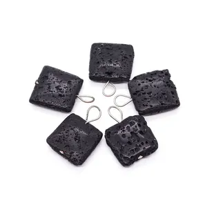 Five square natural black lava stone pendants with silver metal bails on white background