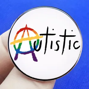 Rainbow Autistic enamel pin featuring an anarchy symbol A on a white round metal badge