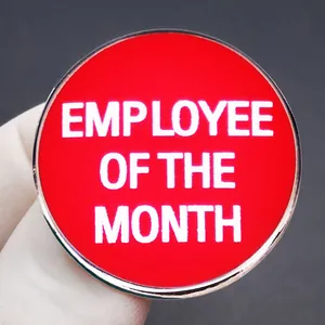 Circular red enamel Employee of the Month badge with polished metallic borders
